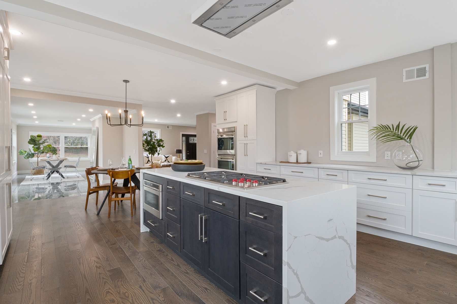 Modern kitchen with a dark island and waterfall countertop