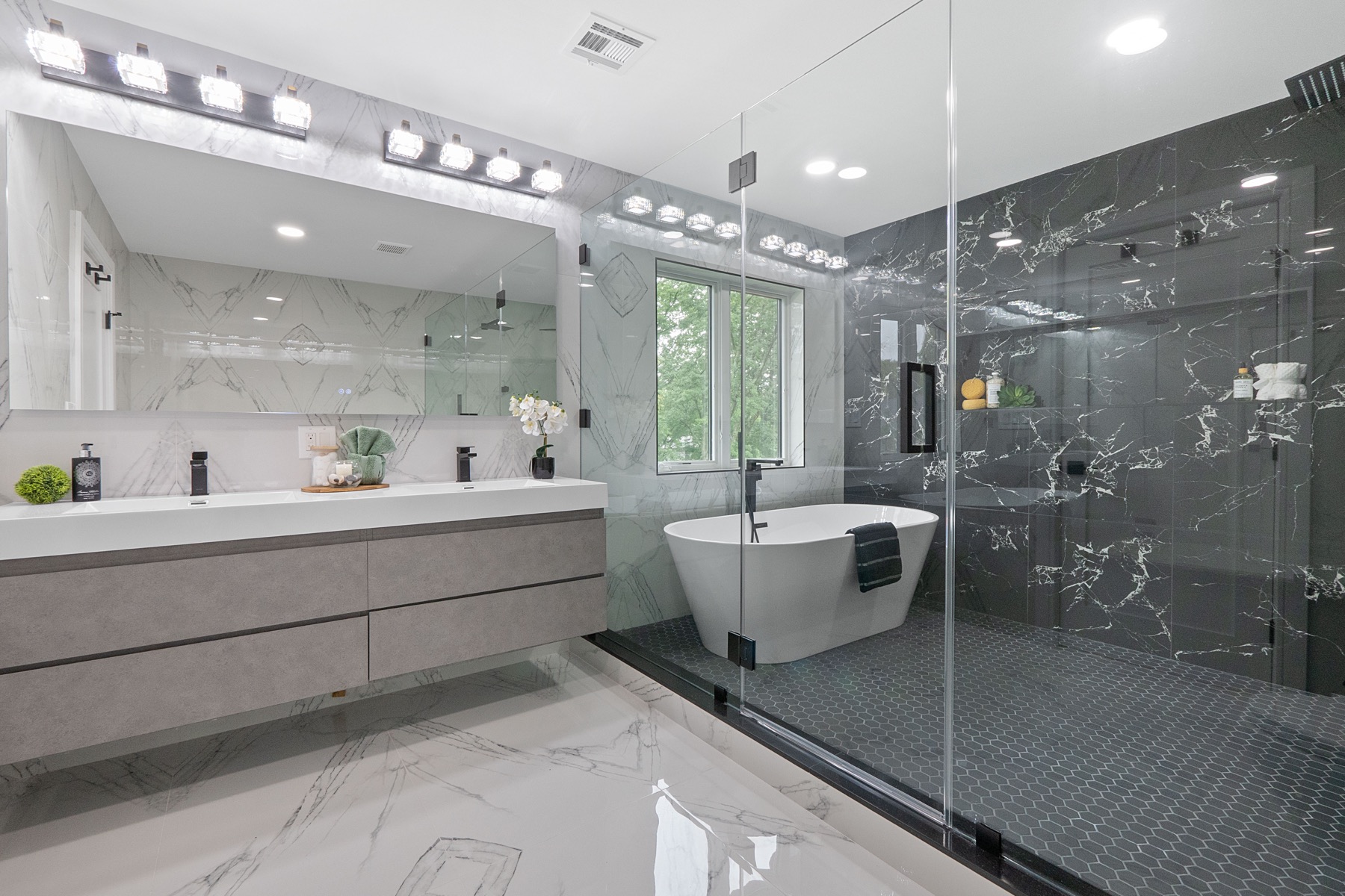 Primary bathroom with black and white marble finishes