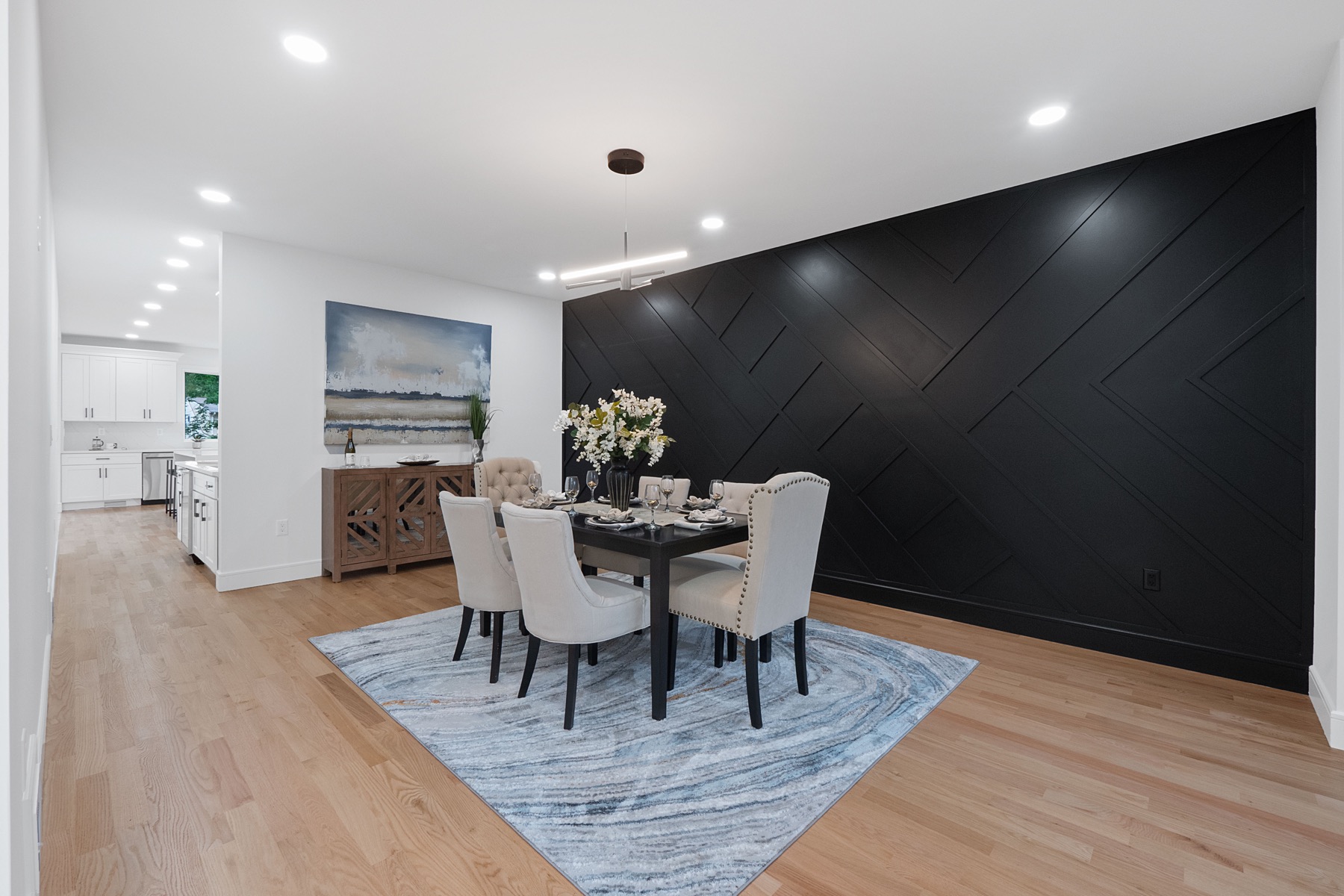 Dining room with a geometric black feature wall
